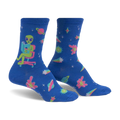 Crew socks in blue with an alien reading a book, planets, stars, and comets. Pink, teal, and green accents. Glow-in-the-dark.