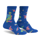 Crew socks in blue with an alien reading a book, planets, stars, and comets. Pink, teal, and green accents. Glow-in-the-dark.