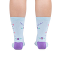 Rear view of the socks on a person's feet, showcasing the back design and the purple heel and toe.