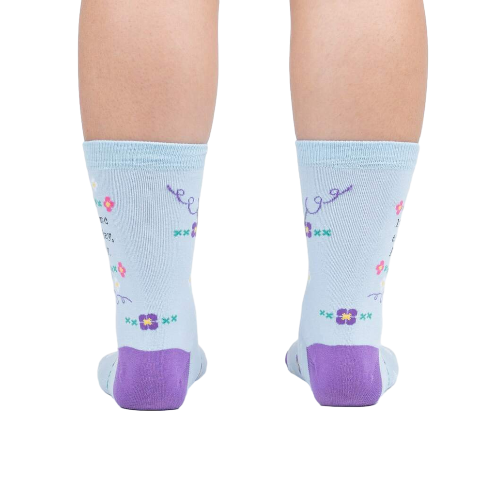 Rear view of the socks on a person's feet, showcasing the back design and the purple heel and toe.