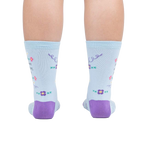 Rear view of the socks on a person's feet, showcasing the back design and the purple heel and toe.