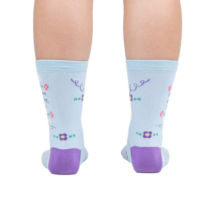 Rear view of the socks on a person's feet, showcasing the back design and the purple heel and toe.