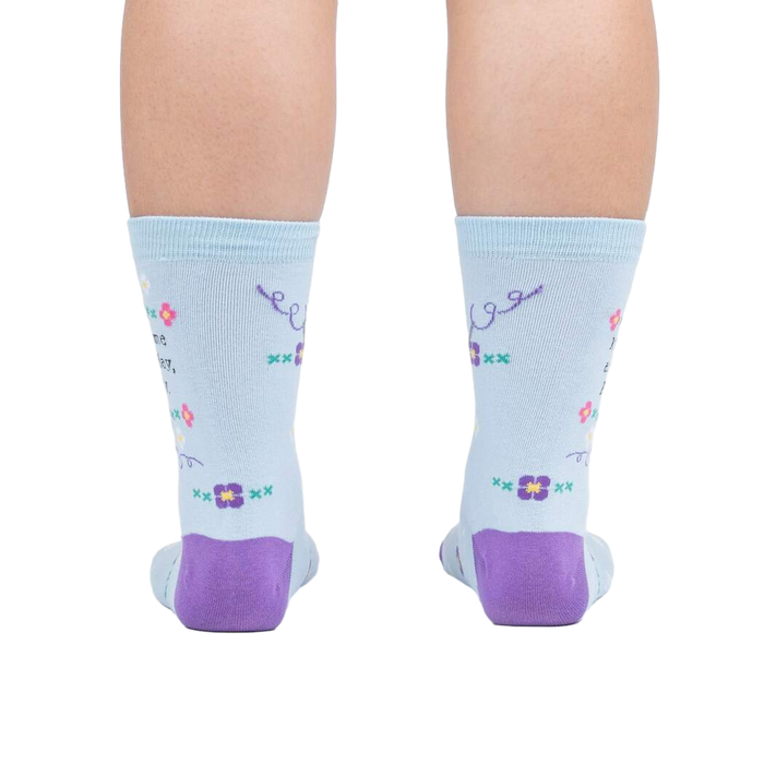 Rear view of the socks on a person's feet, showcasing the back design and the purple heel and toe.