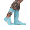 Lifestyle shot of a person's legs wearing the 'My Dear Hedgehog' socks, showcasing the socks on a model with tattoos.