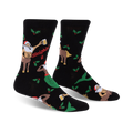 A pair of black crew socks with a festive design. The socks feature a muscular Santa centaur, a mermaid, holly, and the phrase 'Sleighin' It'.