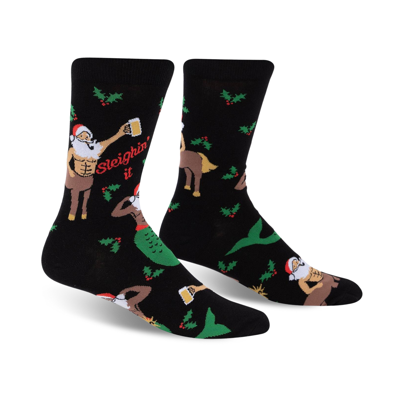 A pair of black crew socks with a festive design. The socks feature a muscular Santa centaur, a mermaid, holly, and the phrase 'Sleighin' It'.