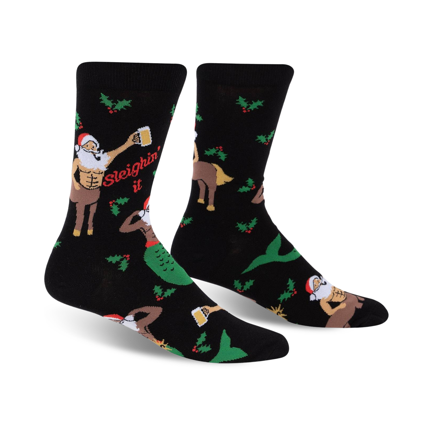 A pair of black crew socks with a festive design. The socks feature a muscular Santa centaur, a mermaid, holly, and the phrase 'Sleighin' It'.