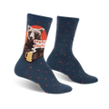 A pair of teal crew socks with a brown bear drinking coffee and the words 'Bearly Awake'.  Red accents and small red polka dots decorate the socks.
