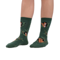Lifestyle shot showing model wearing the Woodland Watcher socks, showcasing their fit and design.