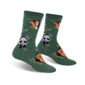 Pair of crew socks in deep green with repeating pattern of squirrels, raccoons, and owls perched on leafy branches.