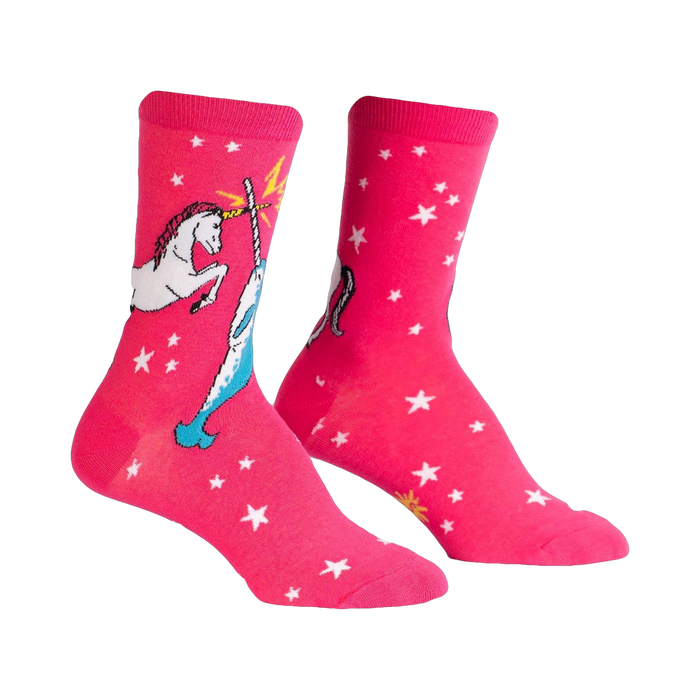 Pair of pink crew socks with a white unicorn and narwhal design battling each other. White stars are scattered across the background.