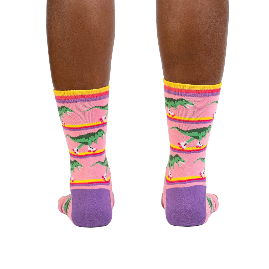 Rear view of a person wearing the Rawr-ler Rink socks, highlighting the full design.