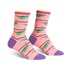 Crew socks in pink, purple, and yellow, featuring a pattern of green dinosaurs roller-skating.