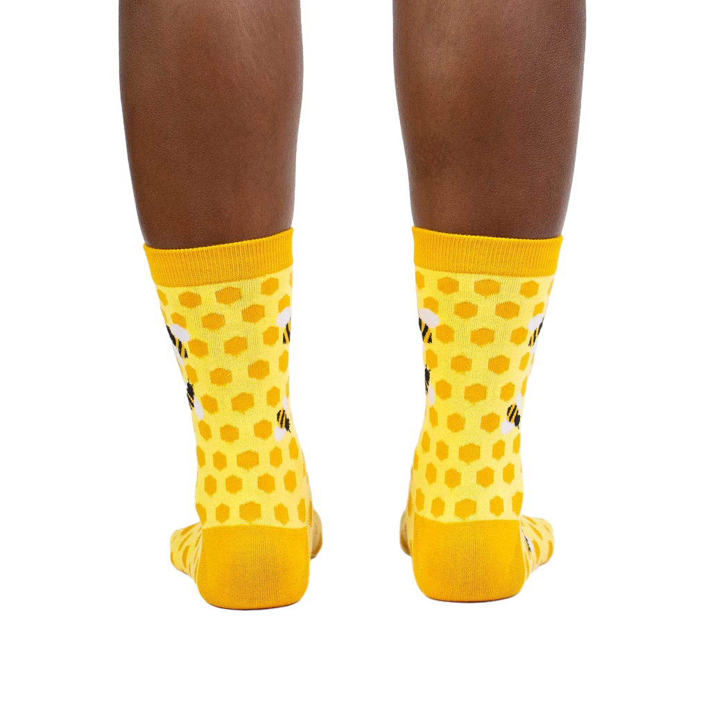 Rear view of the yellow honeycomb bee socks on a model.