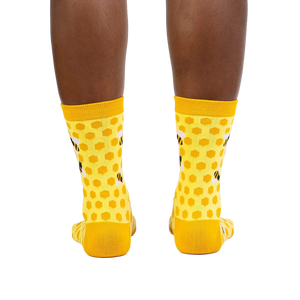 Rear view of the yellow honeycomb bee socks on a model.