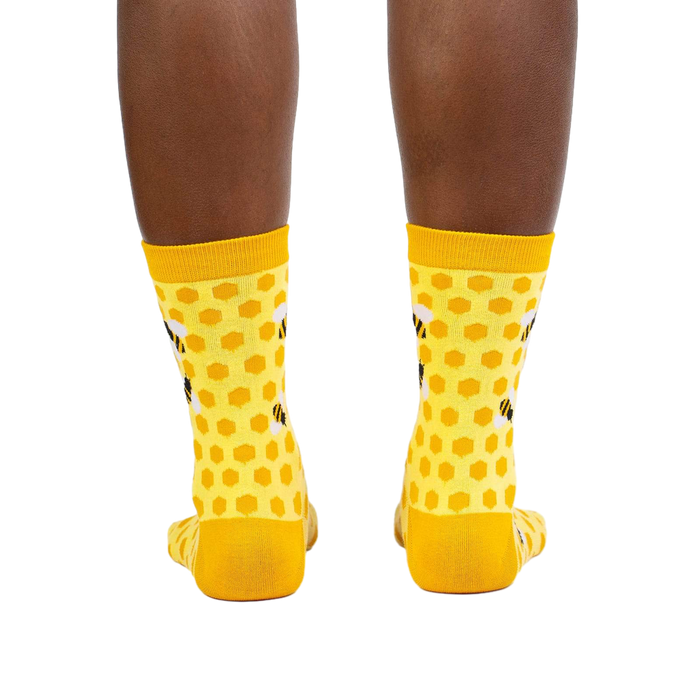 Rear view of the yellow honeycomb bee socks on a model.