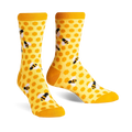 Pair of crew socks in yellow and black. The socks have a honeycomb pattern with little bees.