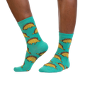 Tacosaurus socks shown on a model's legs, showcasing how they look when worn.