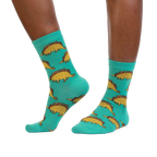 Tacosaurus socks shown on a model's legs, showcasing how they look when worn.