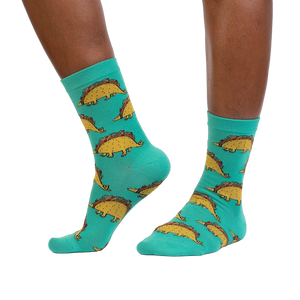 Tacosaurus socks shown on a model's legs, showcasing how they look when worn.