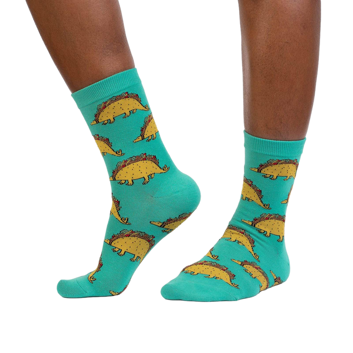 Tacosaurus socks shown on a model's legs, showcasing how they look when worn.