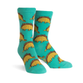 Teal crew socks with a repeating pattern of cute dinosaurs made of tacos. 