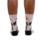 Rear view of model's legs wearing 'Booked For Meow' socks.