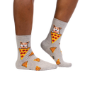 Lifestyle shot of a person wearing the corgi and pizza socks, showing how they look on the feet.