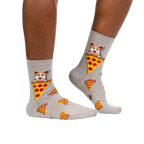 Lifestyle shot of a person wearing the corgi and pizza socks, showing how they look on the feet.