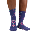 Lifestyle shot: A person's legs wearing the purple floral Venus symbol crew socks against a white background.
