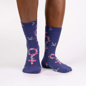 A pair of blue socks with a floral pattern.