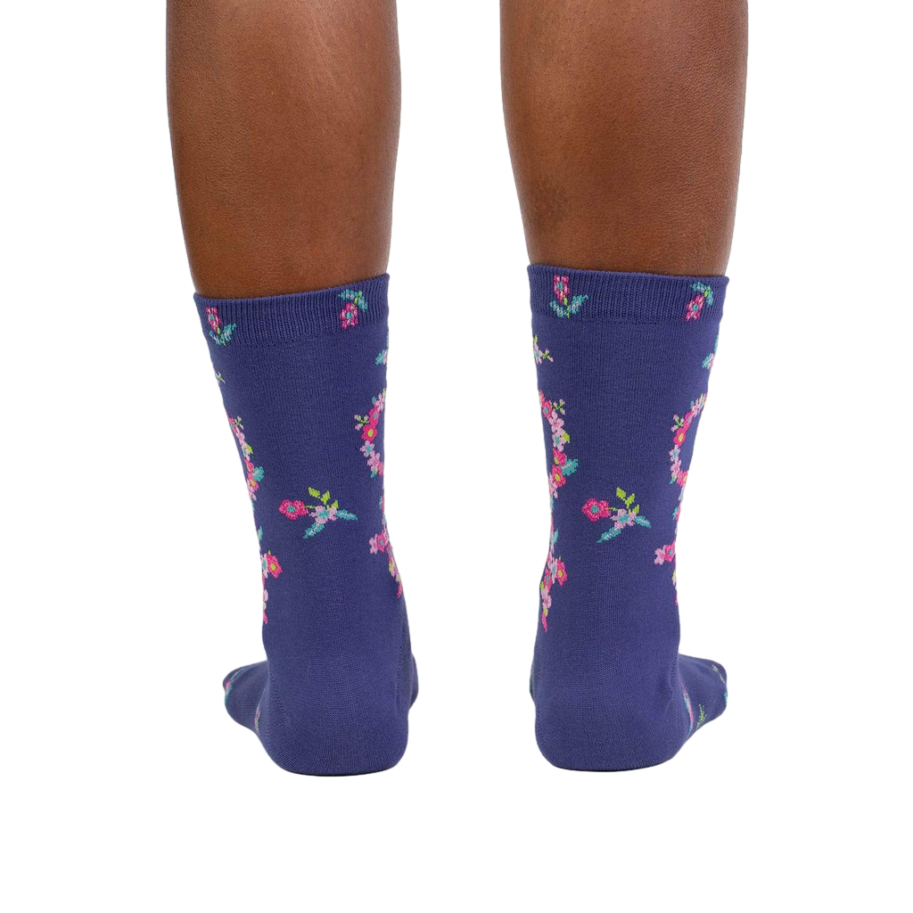 Rear view: A pair of purple floral Venus symbol crew socks shown from the back against a white background.