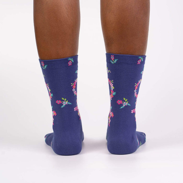 A pair of blue socks with a floral pattern.