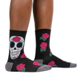 Lifestyle shot: A person's legs wearing the Sugar Skull socks, showcasing how they look when worn.