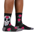 Lifestyle shot: A person's legs wearing the Sugar Skull socks, showcasing how they look when worn.