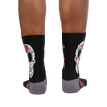 Rear view of the Sugar Skull socks on a person's legs. Shows the back design.