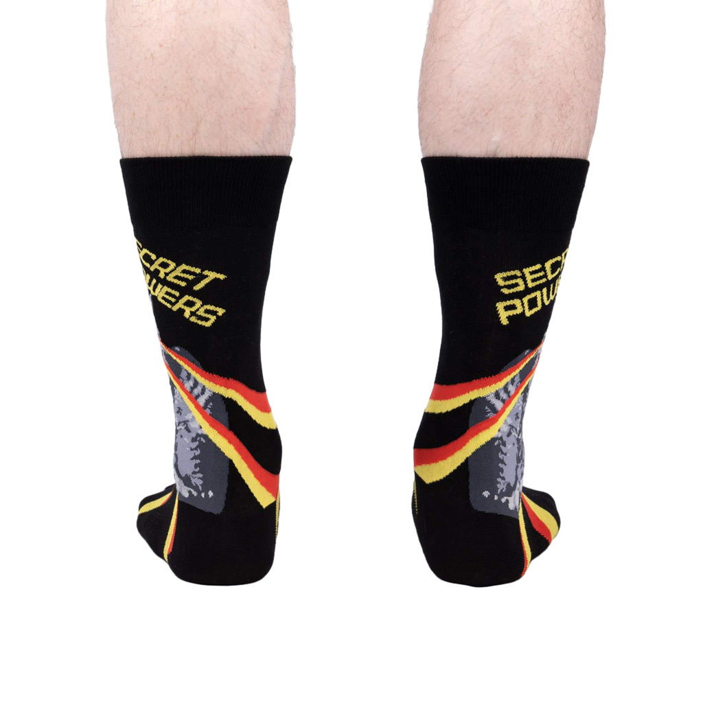 Rear view of a person wearing the 'Secret Powers' socks.  The cat and stripes are partially visible.