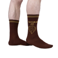 Lifestyle shot of a person wearing brown 'Work It' socks.
