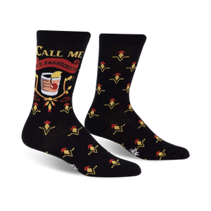 black crew socks with yellow flower pattern. text on left sock says 