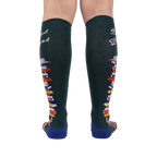 Rear view of the socks showing the design on the back of the legs.  These are dark green knee-high socks with a book stack design.