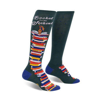 green knee-high socks with a pattern of small blue polka dots, features a stack of books design, and the words 'booked for the weekend' on the top cuff.  