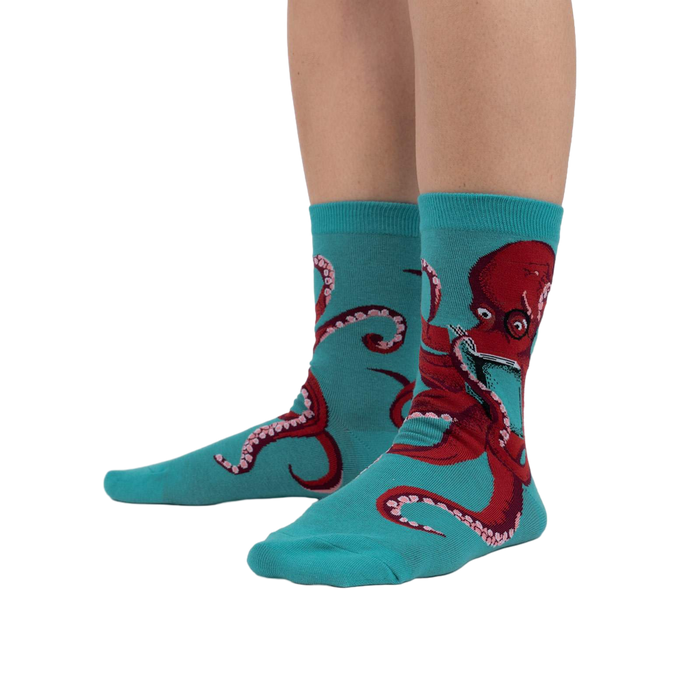 Lifestyle shot showing The Octive Reader socks on a person's feet, showcasing the fit and teal color.
