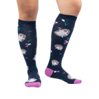 Lifestyle photo showing the 'Rollin' with my Hedgehog' knee-high socks on a person's legs against a white background.