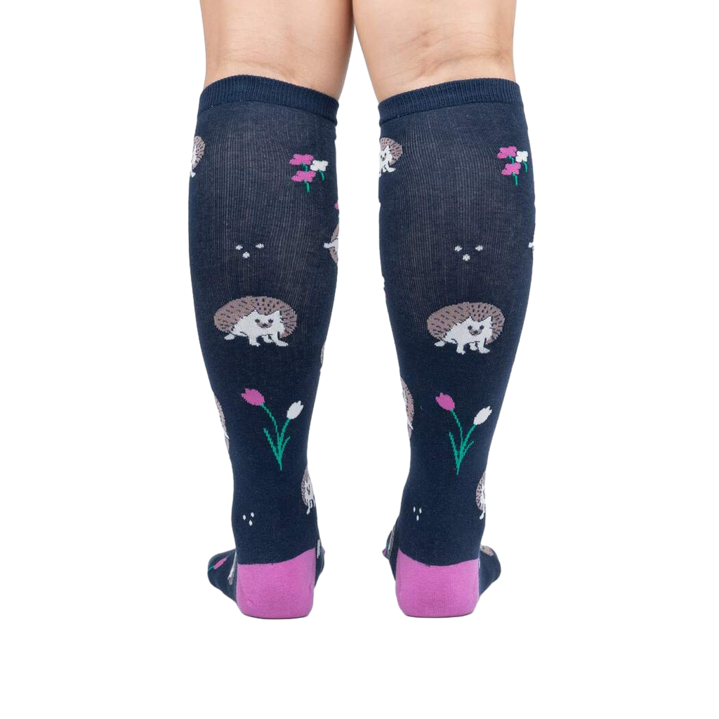 Rear view of a person wearing the 'Rollin' with my Hedgehog' knee-high socks, showcasing the back design and color.