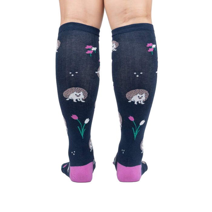 Rear view of a person wearing the 'Rollin' with my Hedgehog' knee-high socks, showcasing the back design and color.