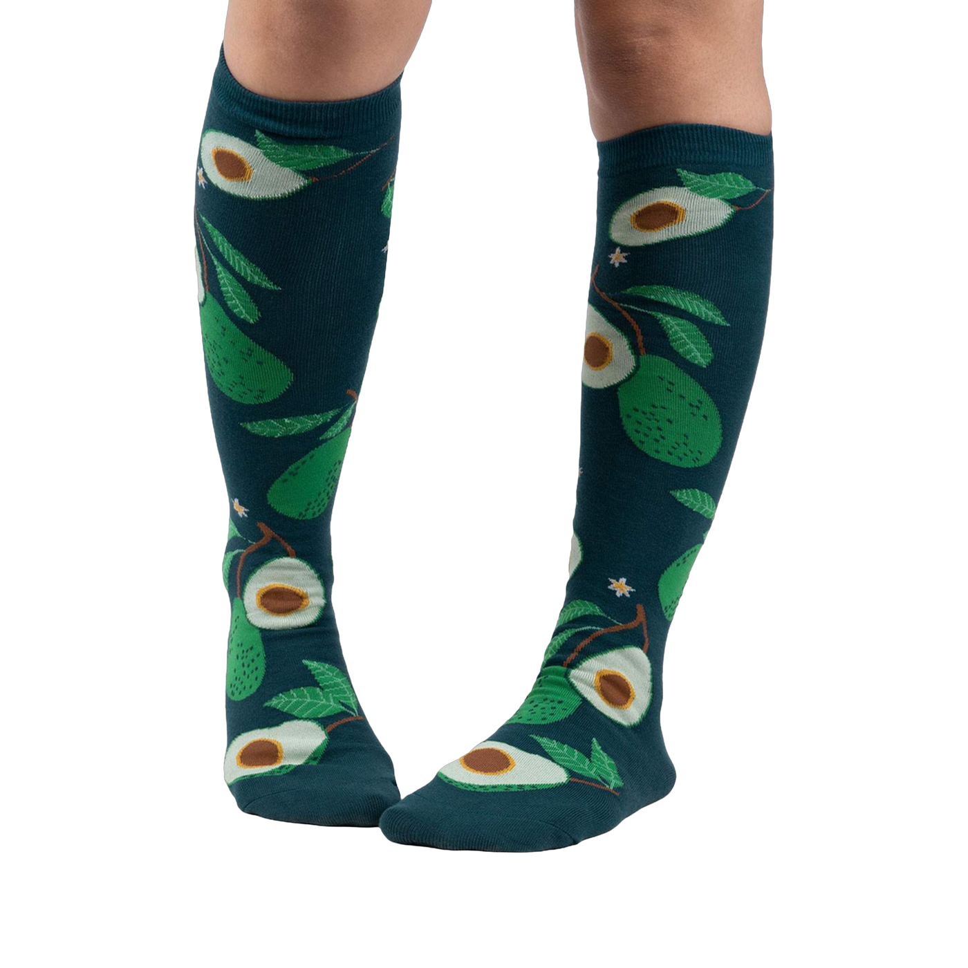 Lifestyle shot showing a person's legs wearing the teal avocado knee-high socks.
