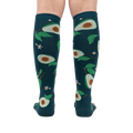 Back view of the teal avocado knee-high socks on a person's legs.