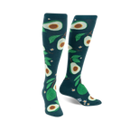 Pair of teal knee-high socks with a fun avocado and leaf pattern. The avocados are various shades of green.