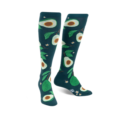 teal knee-high socks with an all-over pattern of avocados, avocado leaves, and white flowers.   