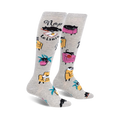 Pair of grey knee-high socks with black cats napping in armchairs and the words 'Nap Leisure'.  Features yellow and pink armchairs and palm trees.